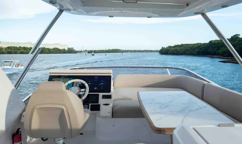 Slide: The Image of Flybridge view of 2022 Azimut 50 Fly yacht, featuring helm and seating area. - 20