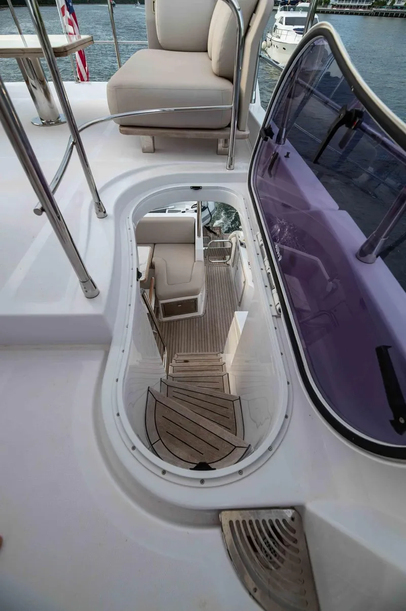 Slide: The Image of 2022 Azimut 50 Fly yacht interior with elegant seating and wooden flooring. - 21