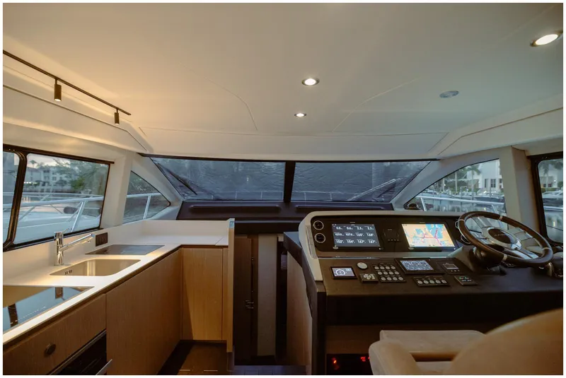 Slide: The Image of Interior of 2022 Azimut Fly yacht, featuring modern helm and sleek kitchen area. - 24