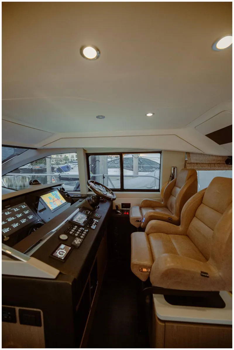 Slide: The Image of Luxurious interior of 2022 Azimut Fly yacht with modern cockpit and plush seating. - 28