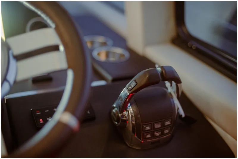 Slide: The Image of Control panel of a 2022 Azimut Fly yacht, featuring modern steering and throttle controls. - 34