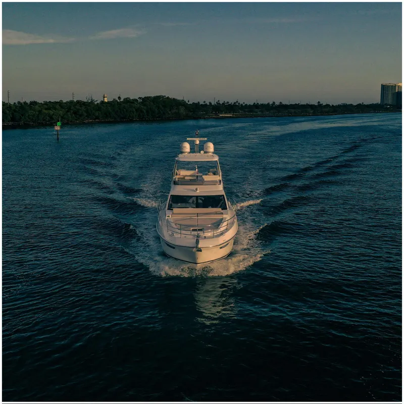 Slide: The Image of Azimut 2022 Fly yacht cruising on a calm waterway at sunset. - 4