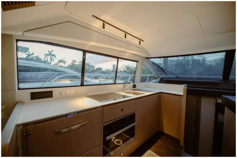 Slide: The Image of Modern kitchen interior of 2022 Azimut Fly yacht with sleek design and large windows. - 40