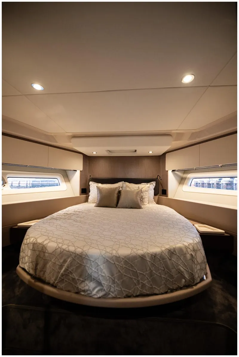 Slide: The Image of Luxurious bedroom interior of 2022 Azimut Fly yacht with elegant bedding and ambient lighting. - 48