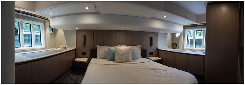 Slide: The Image of Luxurious bedroom interior of 2022 Azimut Fly yacht, featuring elegant design and ample natural light. - 49