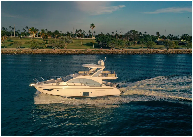 Slide: The Image of Azimut 2022 Fly yacht cruising on a scenic waterway near lush greenery. - 5