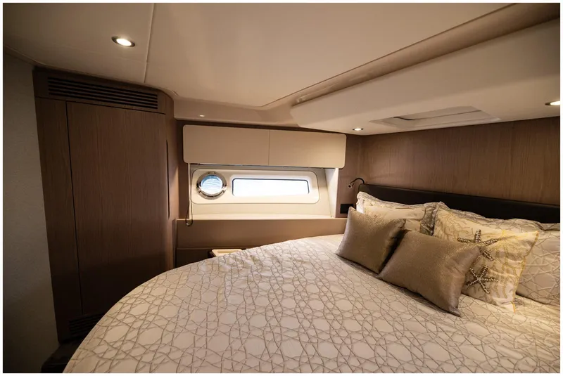 Slide: The Image of Luxurious bedroom interior of 2022 Azimut Fly yacht with elegant bedding and porthole window. - 51