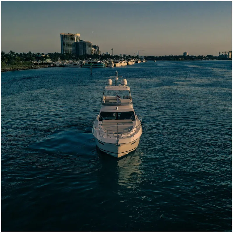 Slide: The Image of Azimut 2022 Fly yacht cruising on a serene waterway at sunset. - 6