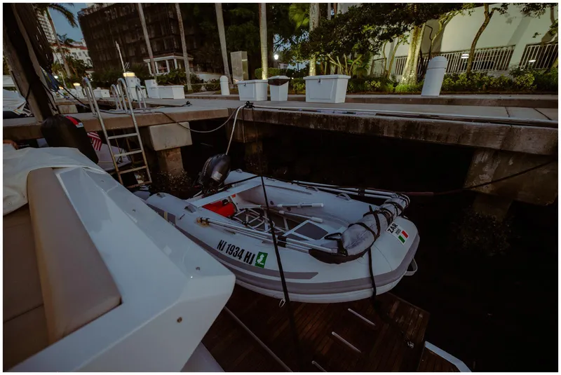Slide: The Image of A 2022 Azimut fly model yacht docked with a small inflatable boat attached. - 9