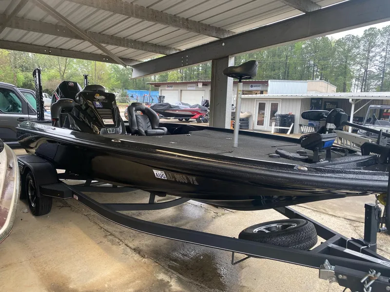 Slide: The Image of 2022 Nitro Z20 Pro boat under a metal canopy, parked on a trailer. - 1