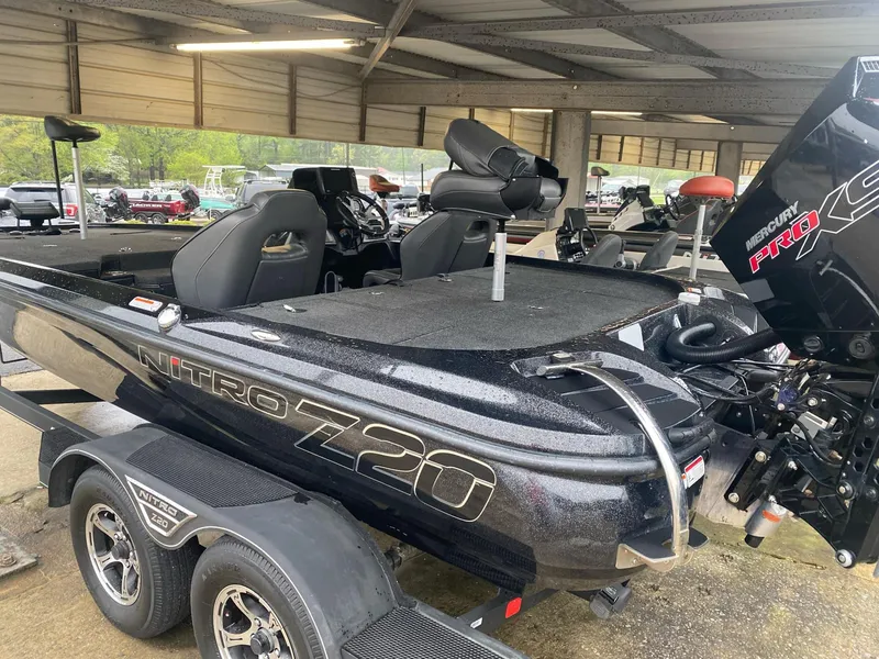 Slide: The Image of 2022 Nitro Z20 Pro boat in a covered storage area, featuring a sleek black design. - 5