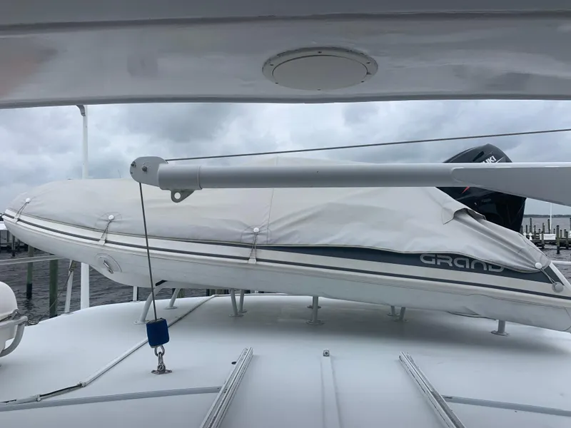 Slide: The Image of 1998 Hatteras 52 Cockpit Motor Yacht with covered dinghy on deck. - 15