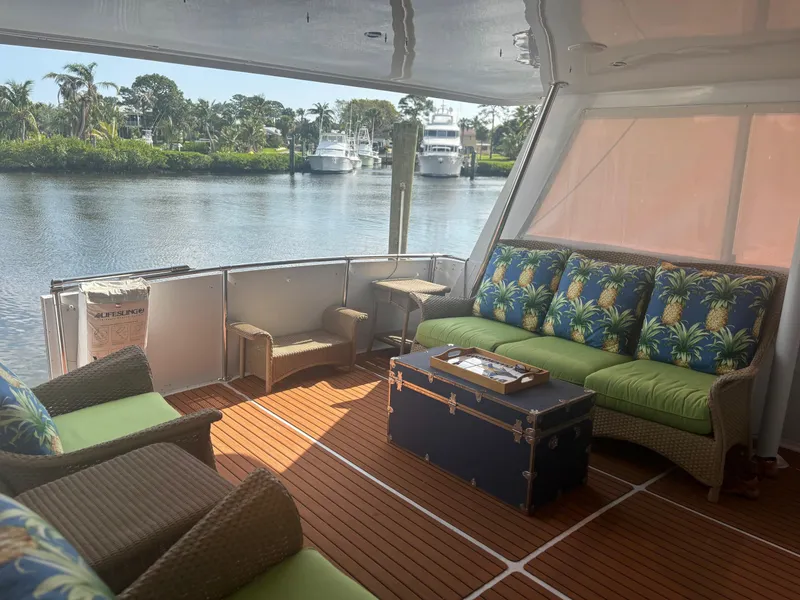 Slide: The Image of Luxurious 1998 Hatteras 52 Cockpit Motor Yacht interior with tropical-themed seating. - 17