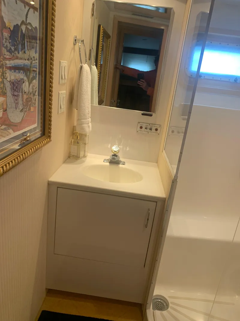 Slide: The Image of Bathroom interior of 1998 Hatteras 52 Cockpit Motor Yacht with sink and mirror. - 25
