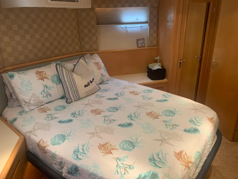 Slide: The Image of Cozy bedroom in 1998 Hatteras 52 Cockpit Motor Yacht with nautical-themed bedding. - 28