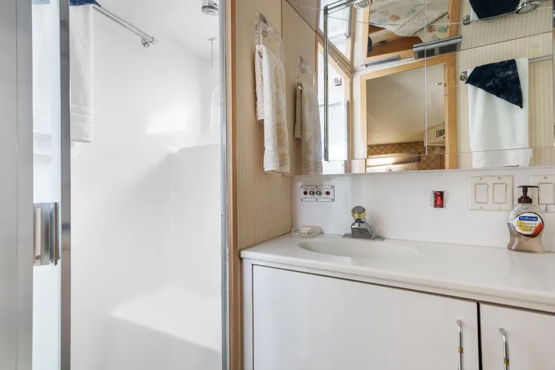 Slide: The Image of Bathroom interior of 1998 Hatteras 52 Cockpit Motor Yacht, featuring sink and shower. - 30