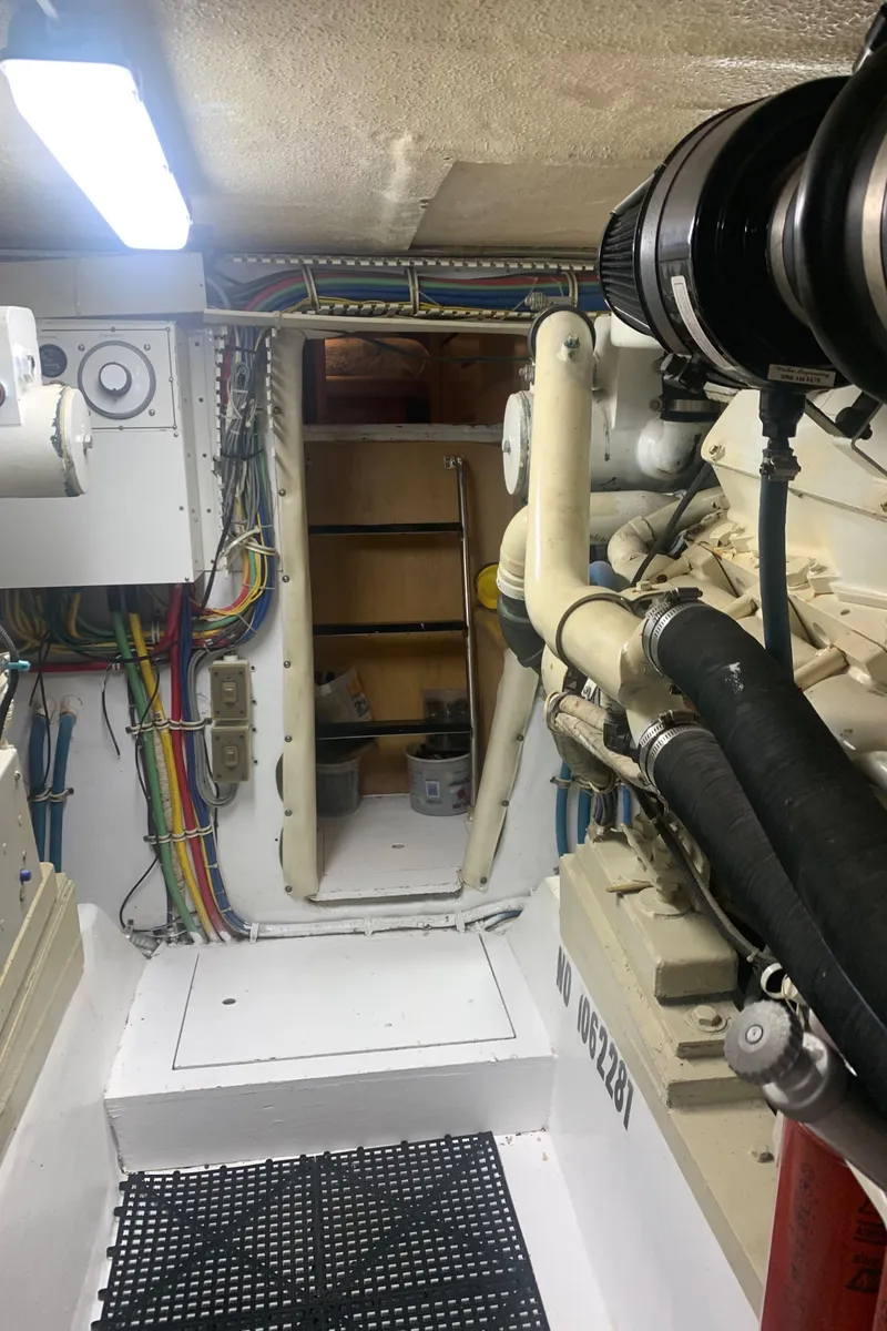 Slide: The Image of Engine room of 1998 Hatteras 52 Cockpit Motor Yacht with visible wiring and machinery. - 33