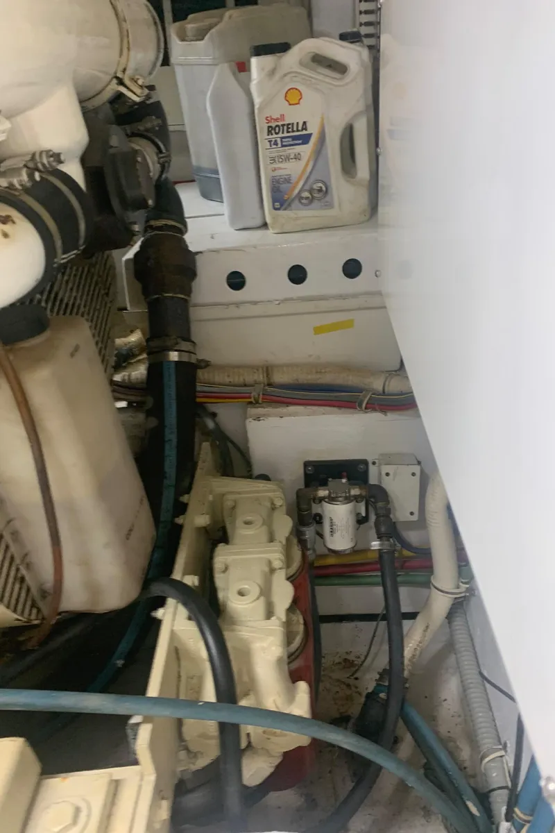 Slide: The Image of Engine room of 1998 Hatteras 52 Cockpit Motor Yacht with oil container and machinery. - 37