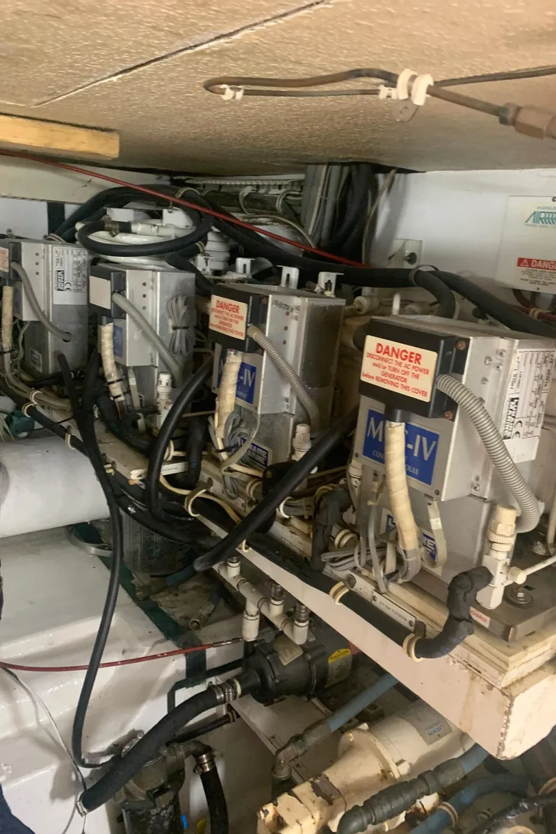 Slide: The Image of Engine room of 1998 Hatteras 52 Cockpit Motor Yacht with electrical components. - 38