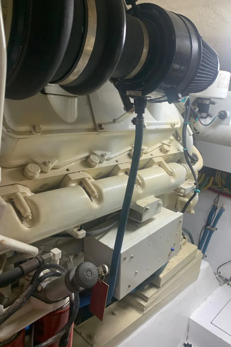 Slide: The Image of Engine room of 1998 Hatteras 52 Cockpit Motor Yacht, showcasing mechanical components. - 39