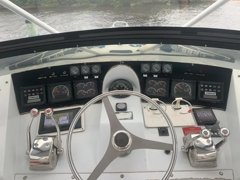 Slide: The Image of Cockpit view of 1998 Hatteras 52 Cockpit Motor Yacht with steering wheel and control panels. - 6
