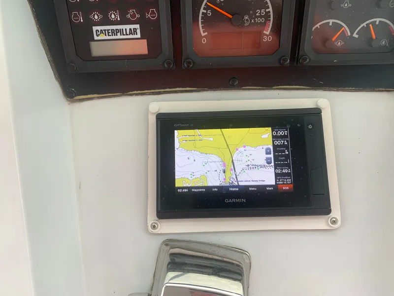 Slide: The Image of Control panel of a 1998 Hatteras 52 Cockpit Motor Yacht with Garmin navigation display. - 7
