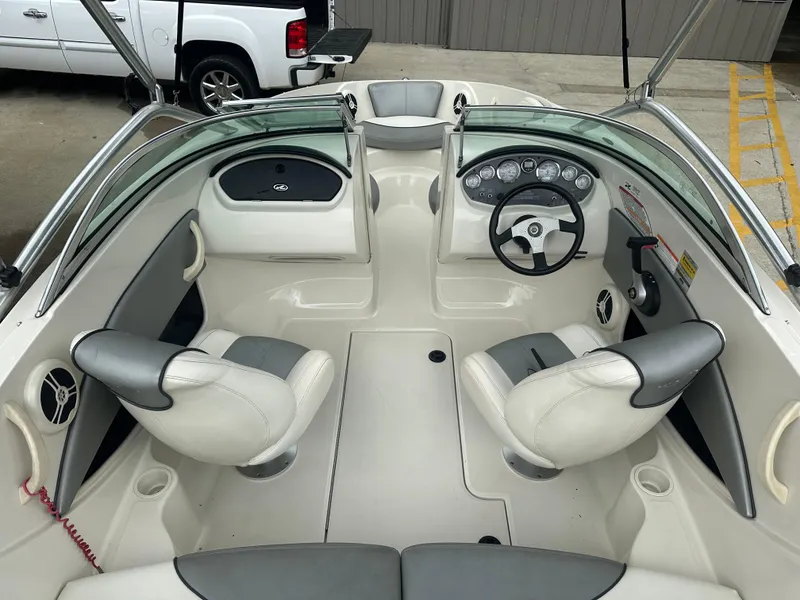 Slide: The Image of 2008 Sea Ray 185 Sport boat interior with steering wheel and seating. - 2