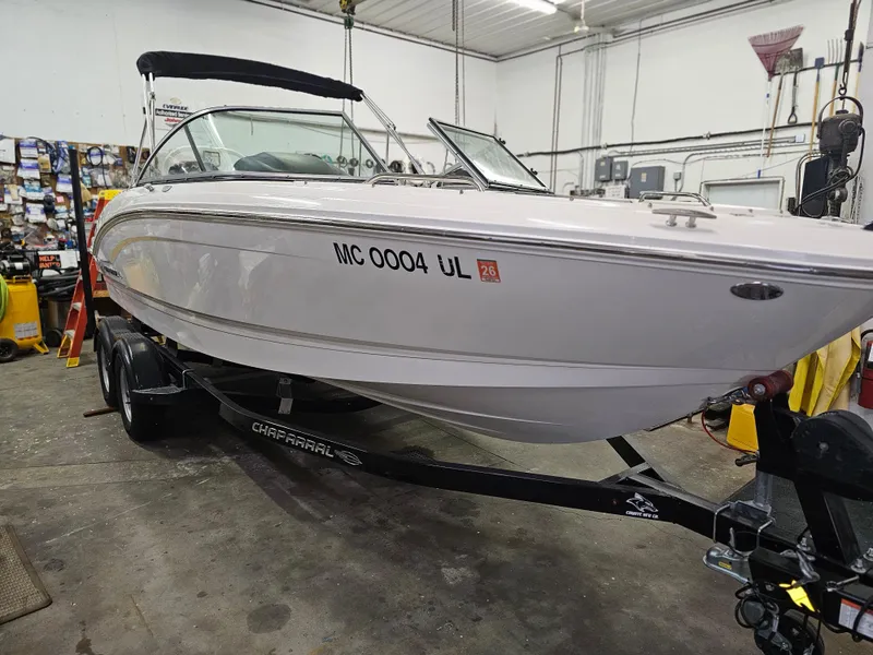 Slide: The Image of 2020 Chaparral 21 SSi OB boat on trailer in garage setting. - 2