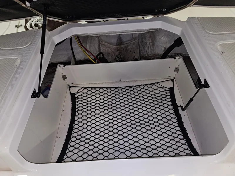 Slide: The Image of Open storage compartment in 2020 Chaparral 21 SSi OB boat with netting. - 22