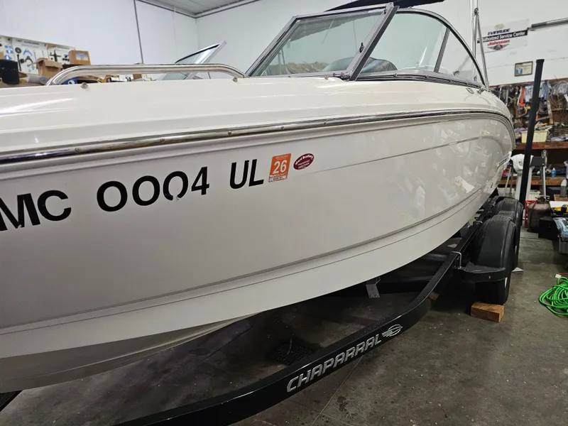 Slide: The Image of 2020 Chaparral 21 SSi OB boat on trailer in garage setting. - 3