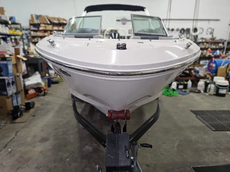 Slide: The Image of 2020 Chaparral 21 SSi OB boat in a workshop setting, front view. - 4