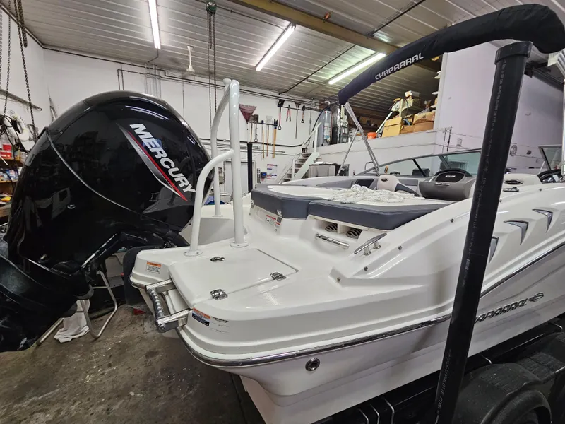 Slide: The Image of 2020 Chaparral 21 SSi OB boat with Mercury outboard engine in a garage. - 5