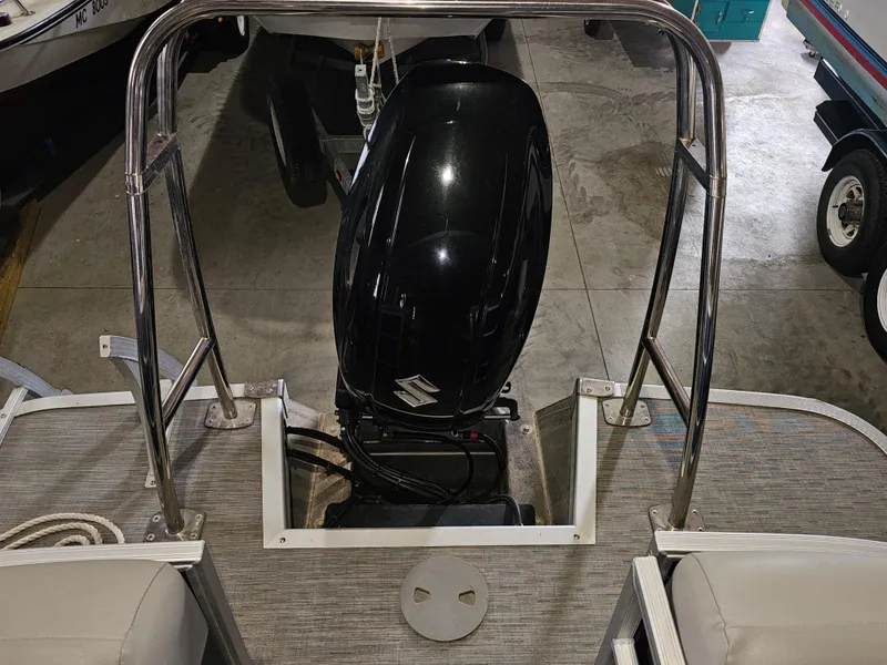 Slide: The Image of 2020 Chaparral 21 SSi OB boat with Suzuki outboard motor in a garage. - 7