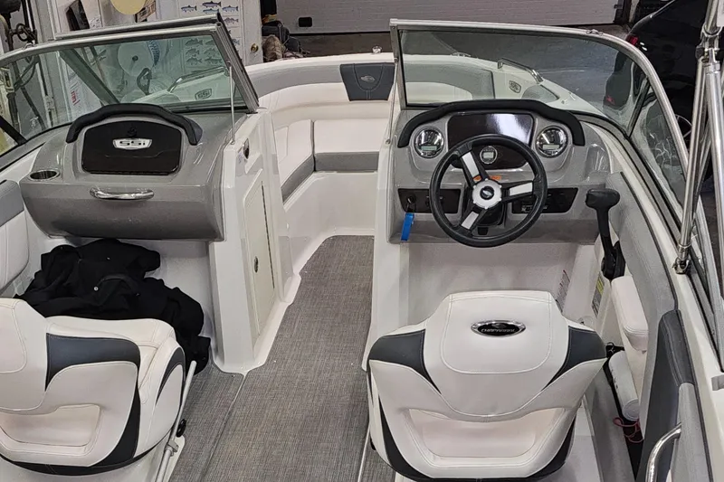 Slide: The Image of 2020 Chaparral 21 SSi OB boat interior with steering wheel and seating. - 9