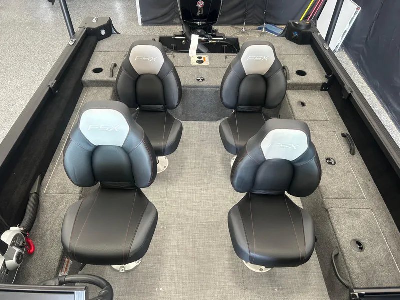 Slide: The Image of 2024 Alumacraft Competitor FSX 185 boat interior with four black and gray seats. - 12