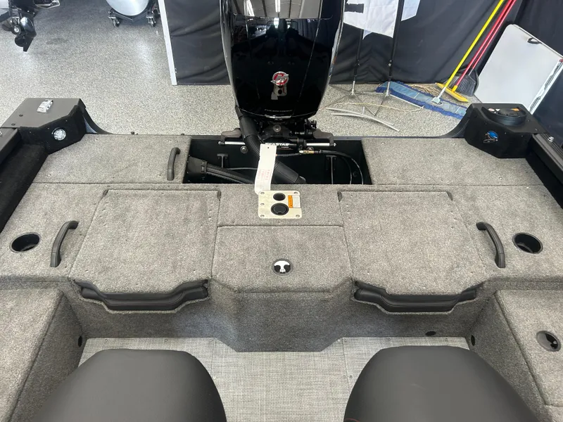 Slide: The Image of 2024 Alumacraft Competitor FSX 185 boat interior with motor and storage compartments. - 13