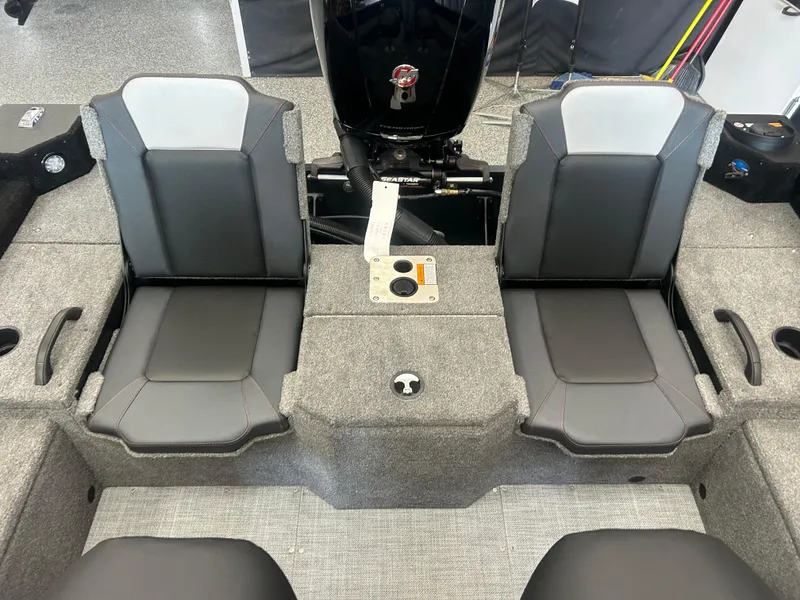 Slide: The Image of 2024 Alumacraft Competitor FSX 185 boat interior with dual seats and motor. - 14