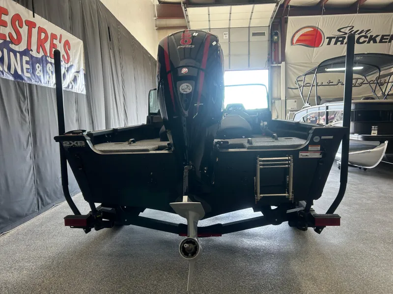 Slide: The Image of 2024 Alumacraft Competitor FSX 185 boat in showroom, rear view with motor and ladder. - 2