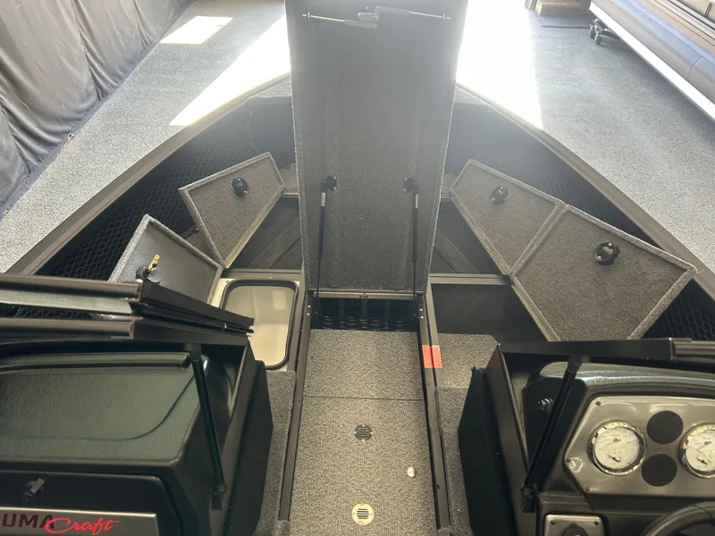 Slide: The Image of 2024 Alumacraft Competitor FSX 185 boat interior with open storage compartments. - 6