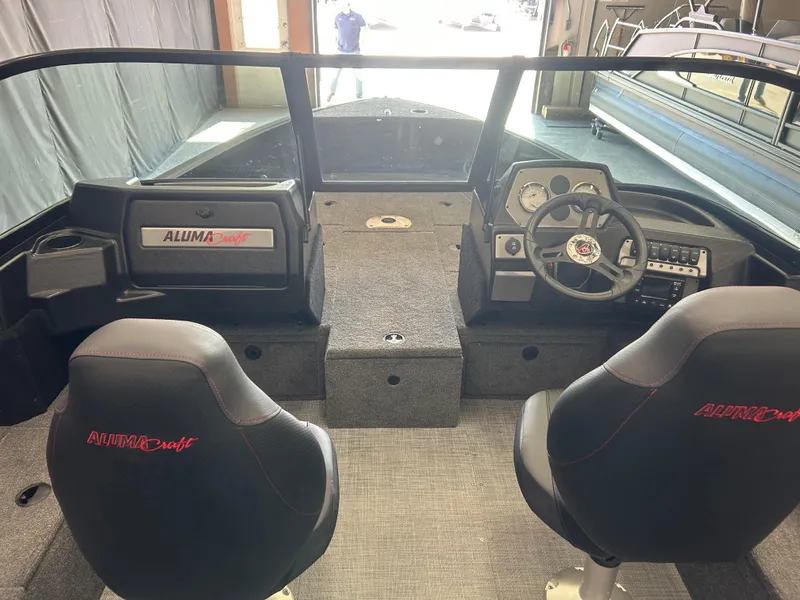 Slide: The Image of 2024 Alumacraft Competitor FSX 185 boat interior with dual seats and steering console. - 8