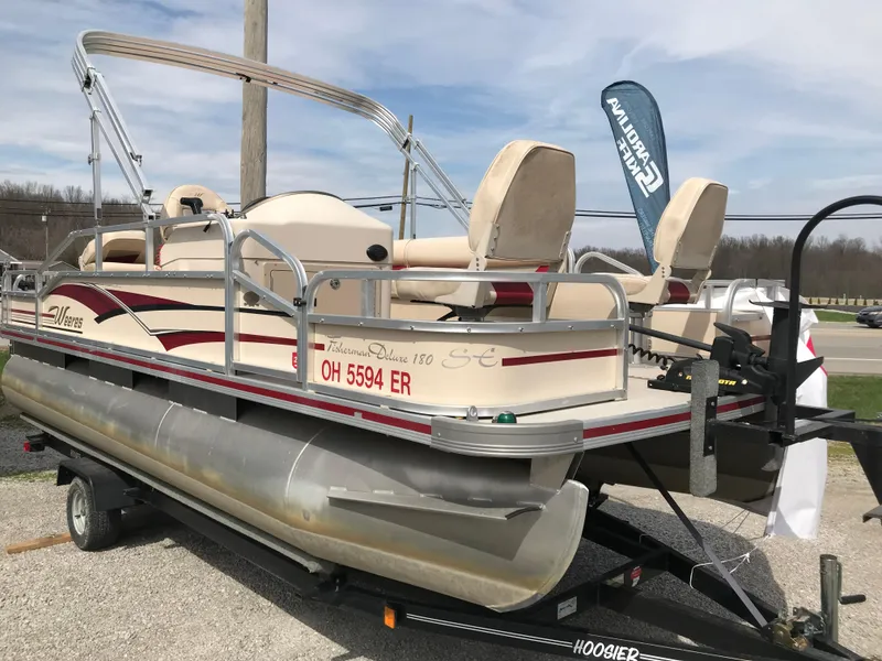 Slide: The Image of 2010 Weeres Fisherman Deluxe 180 pontoon boat on trailer, beige and red design. - 0