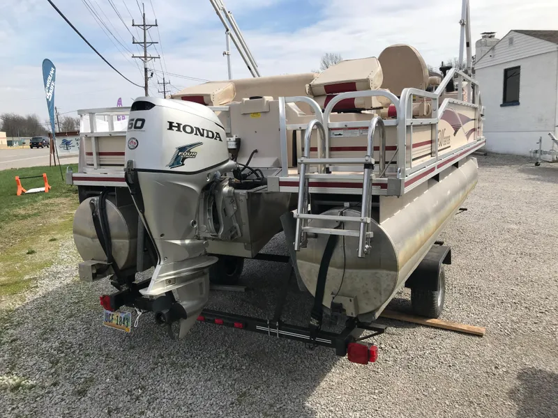 Slide: The Image of 2010 Weeres Fisherman Deluxe 180 pontoon boat with Honda outboard motor, parked on gravel. - 1