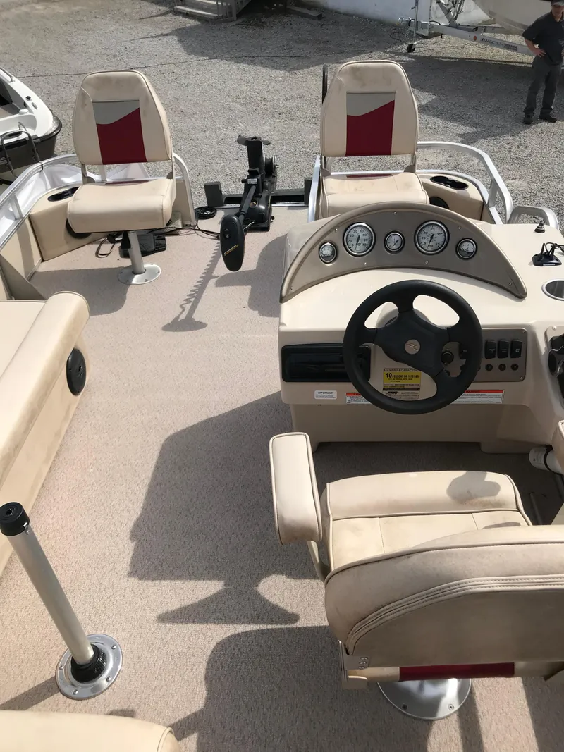 Slide: The Image of 2010 Weeres Fisherman Deluxe 180 boat interior with steering wheel and seating. - 5