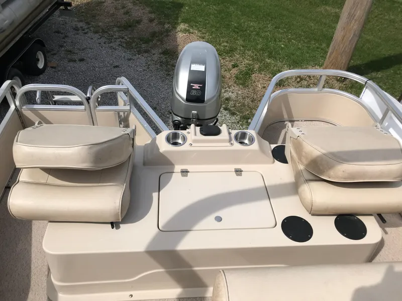 Slide: The Image of 2010 Weeres Fisherman Deluxe 180 boat interior with seating and motor. - 6