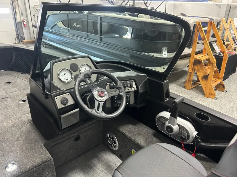 Slide: The Image of 2024 Alumacraft Competitor FSX 175 boat interior with steering wheel and dashboard controls. - 10