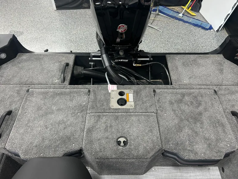 Slide: The Image of 2024 Alumacraft Competitor FSX 175 boat interior with carpeted storage compartments. - 15