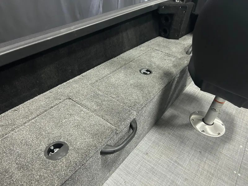 Slide: The Image of 2024 Alumacraft Competitor FSX 175 interior with gray carpeted storage and seating area. - 19