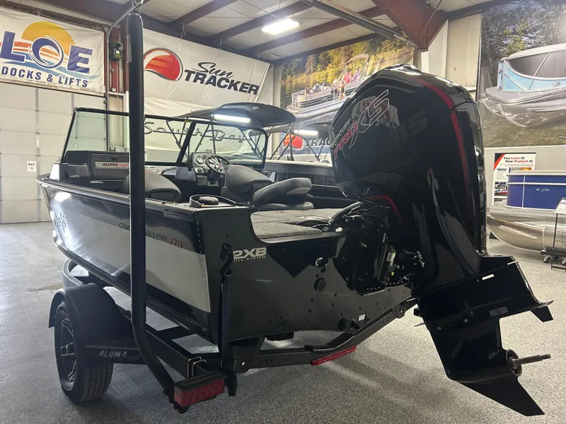 Slide: The Image of 2024 Alumacraft Competitor FSX 175 boat in showroom, featuring powerful outboard motor. - 4