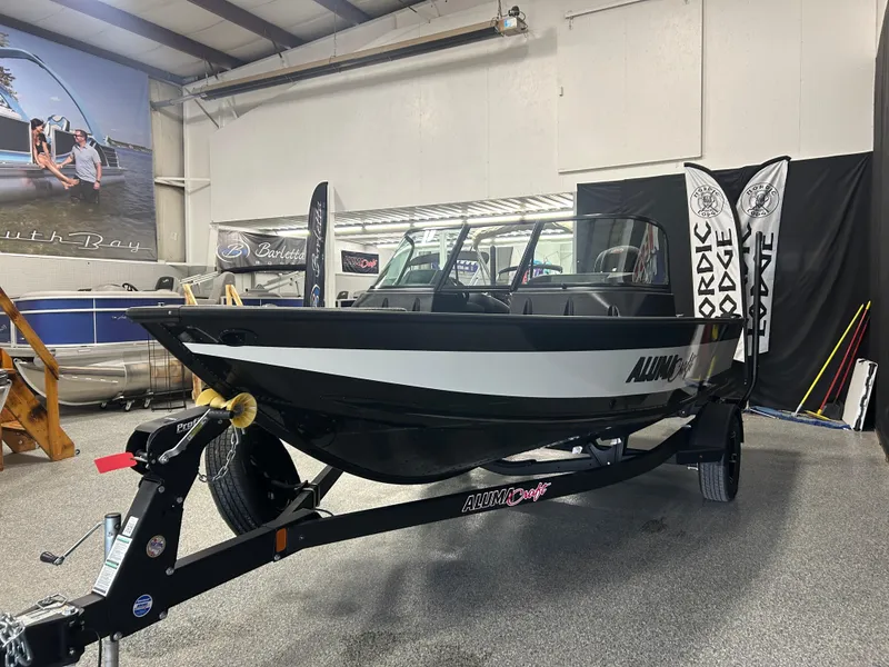 Slide: The Image of 2024 Alumacraft Competitor FSX 175 boat displayed indoors on a trailer. - 5