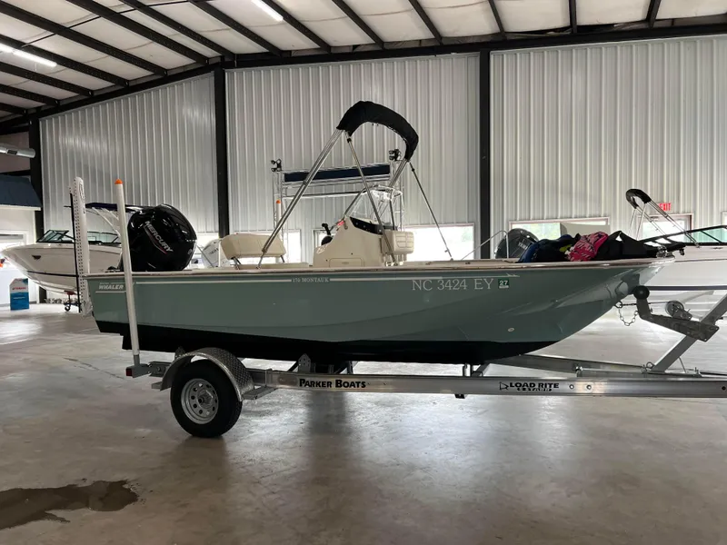 Slide: The Image of 2022 Boston Whaler 170 Montauk boat on trailer in indoor storage facility. - 7